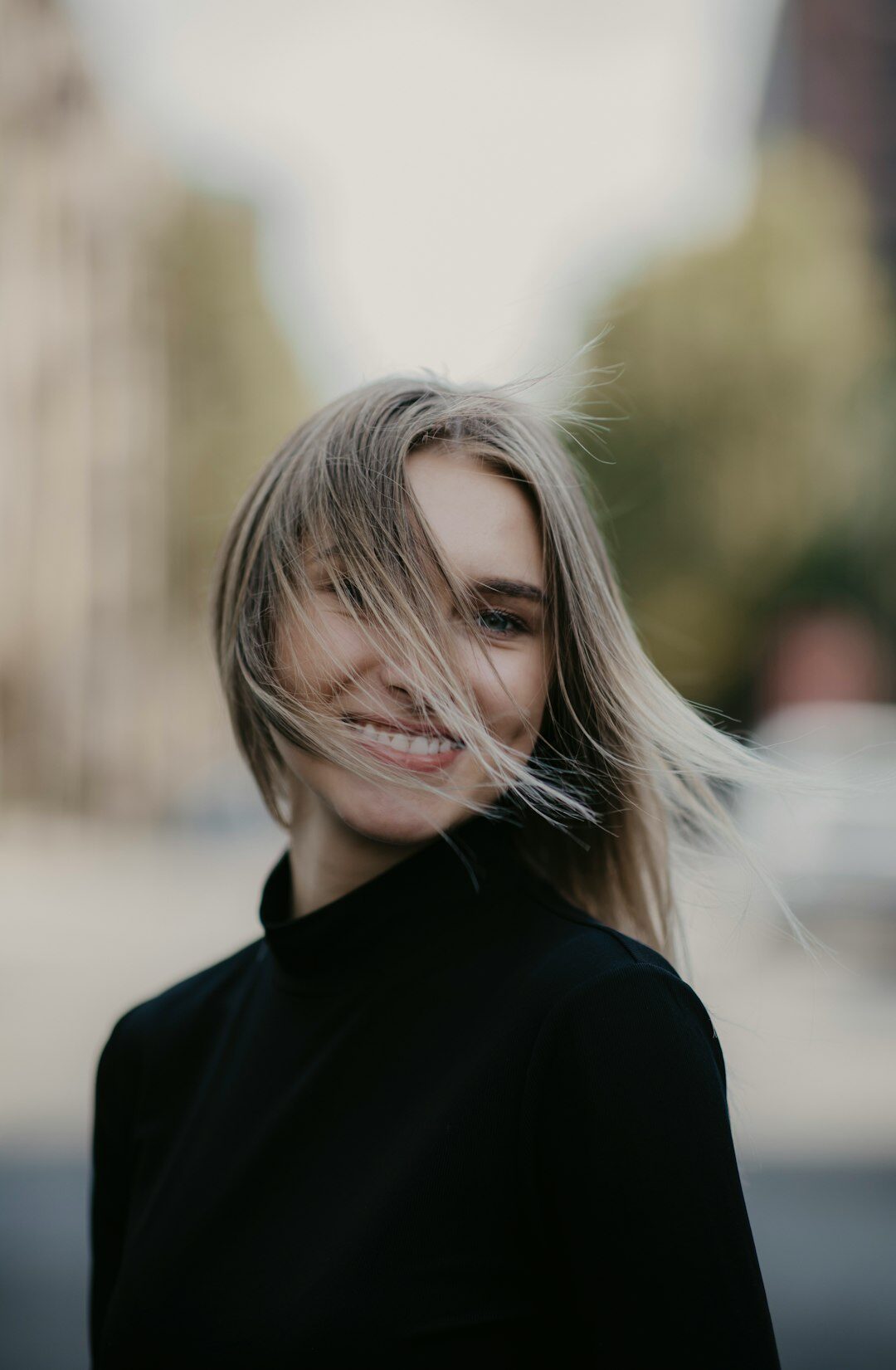 Portrait of a woman with styled hair smiling